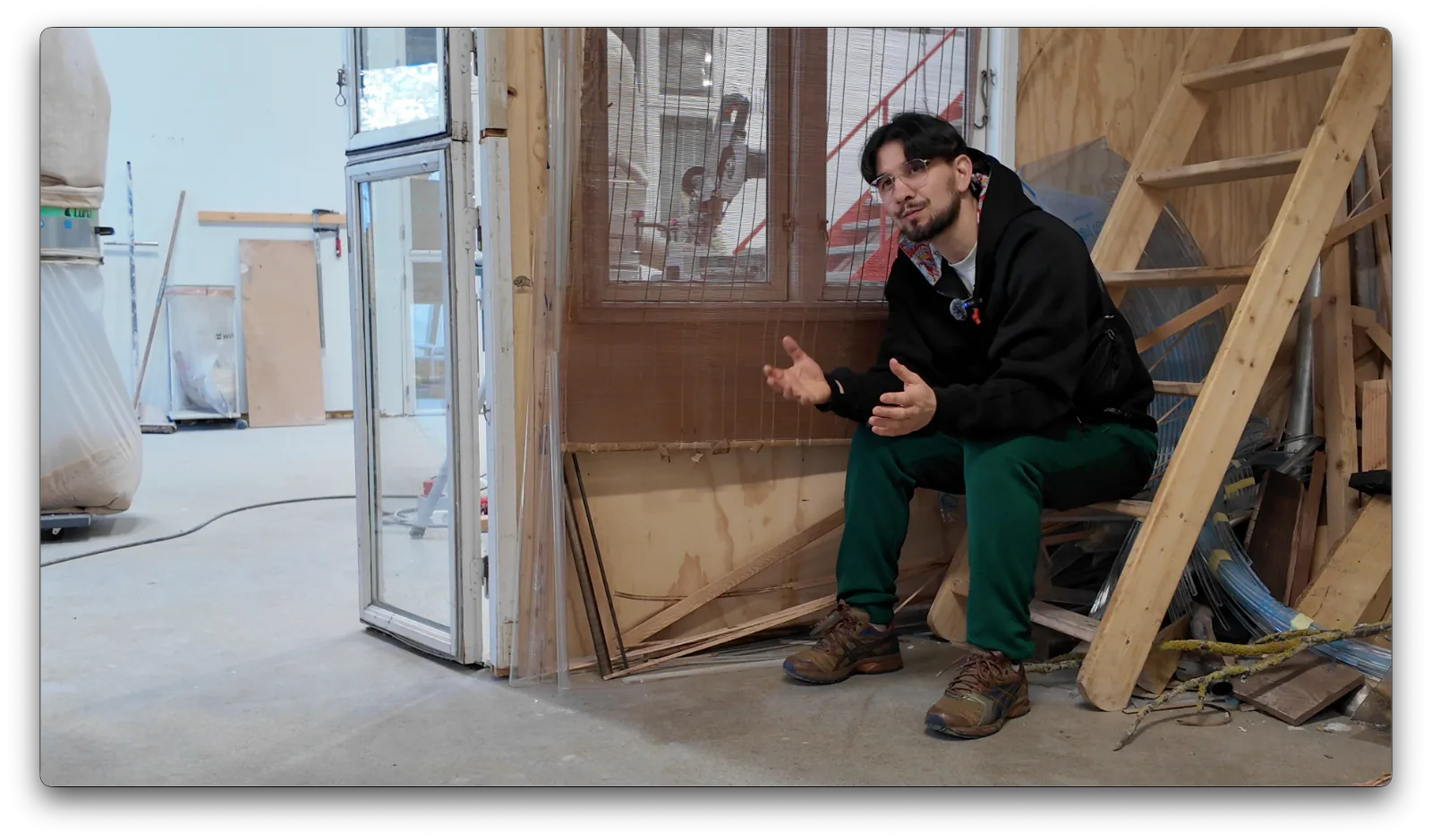 A documentary participant speaking in an art studio